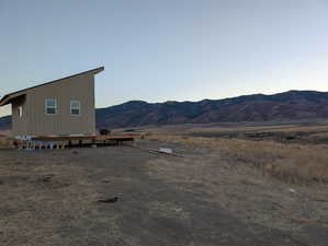 View of mountain backdrop with rural landscape