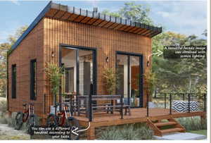 Rear view of property featuring a deck and brick siding