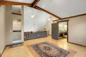 Unfurnished living room featuring beam ceiling, high vaulted ceiling, and a ceiling fan