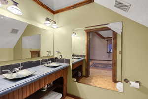 Full bath with double vanity and crown molding