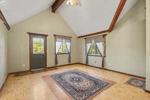 Foyer with beam ceiling, high vaulted ceiling, plenty of natural light, and a ceiling fan