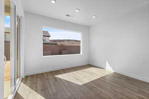 Empty room featuring light wood finished floors and recessed lighting