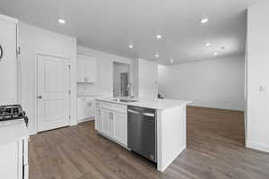 Kitchen with white cabinets, dishwasher, a kitchen island with sink, dark wood-type flooring, and recessed lighting