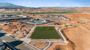 Aerial view of property's location featuring a mountainous background and a pool