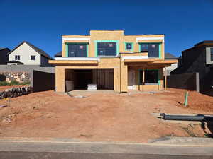 View of front facade featuring stucco siding