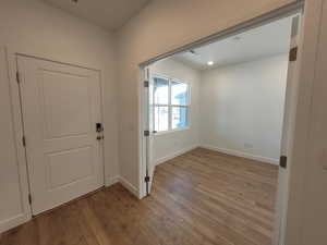 Entrance foyer with dark wood-style flooring and baseboards