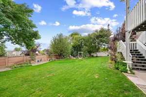 Fenced backyard with stairway