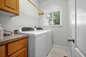 Laundry area with cabinet space and washer and dryer