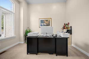 Flexible office, sitting room or other off the front door featuring clear glass French doors.