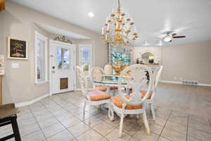 Dining space with bay window, access to covered deck, a chandelier, light tile patterned floors, ceiling fan, and recessed lighting