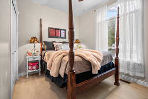 Bedroom featuring light wood finished floors and baseboards