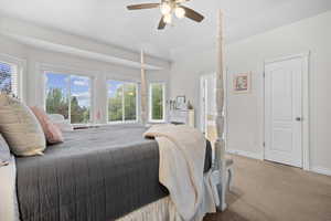Carpeted bedroom with a ceiling fan and connected bathroom