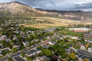 Aerial overview of property's location with a mountainous background and nearby suburban area