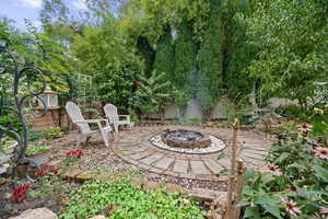 View of yard with a patio and a fire pit