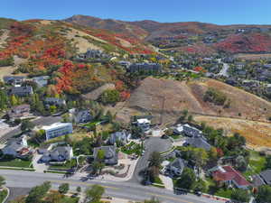 Aerial overview of property's location featuring nearby suburban area and mountains