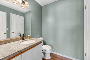 Bathroom with vanity and dark wood finished floors