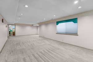 Spare room with light colored carpet and recessed lighting