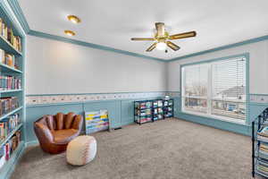 Game room with wallpapered walls, carpet floors, ornamental molding, a textured ceiling, and a ceiling fan
