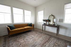 Living area with wood finished floors and healthy amount of natural light