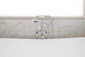 Bathroom view of a sink and a freestanding tub