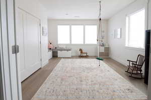 Sitting room featuring baseboards and light wood-type flooring