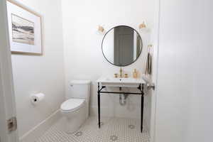 Bathroom with baseboards and tile patterned flooring