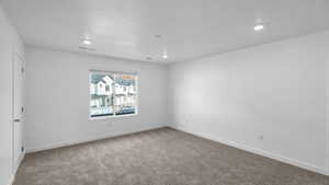 Spare room with light colored carpet and recessed lighting