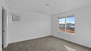 Empty room featuring carpet flooring and baseboards
