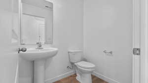 Bathroom with baseboards and wood finished floors