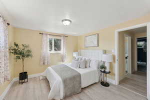Bedroom featuring wood finished floors and a textured ceiling