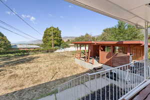 View of backyard and carport from deck