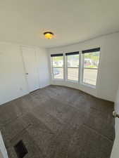 2nd Bedroom featuring carpet floors and a textured ceiling