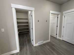 Hall featuring light wood-type flooring and baseboards