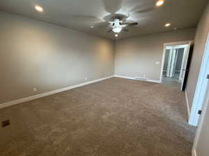Master bedroom featuring recessed lighting, carpet floors, and a ceiling fan