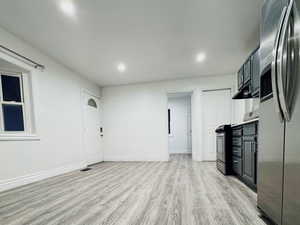 Unfurnished living room with light wood finished floors and recessed lighting