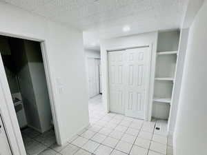 Unfurnished bedroom featuring light tile patterned flooring and a closet