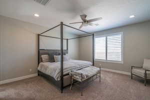 Bedroom with carpet floors, ceiling fan, recessed lighting, and a textured ceiling