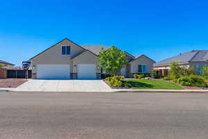 Ranch-style house with stone siding, concrete driveway, stucco siding, an attached garage, and a tiled roof