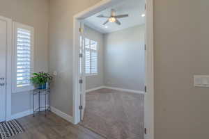 Corridor featuring wood finished floors, carpet, and recessed lighting