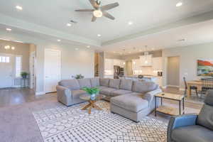 Living room with recessed lighting, light wood-style floors, and ceiling fan