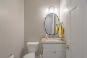 Half bath featuring vanity and toilet