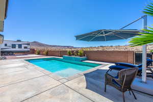 View of pool featuring a patio area, a fenced backyard, and a mountain view