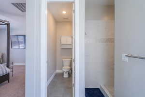 Full bathroom featuring a stall shower, connected bathroom, and light carpet