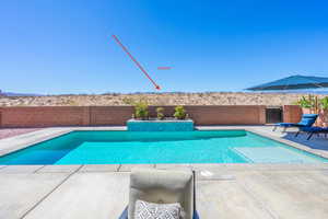 View of pool with a fenced backyard and a patio