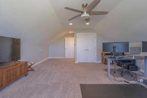 Home office featuring lofted ceiling, light colored carpet, ceiling fan, a textured ceiling, and recessed lighting