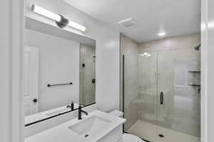 Bathroom with a shower stall and vanity