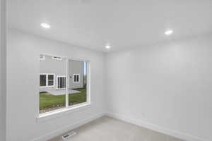 Spare room featuring light colored carpet and recessed lighting