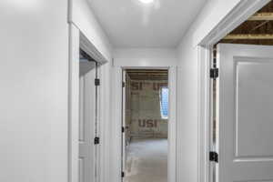 Hallway featuring concrete flooring
