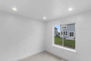 Unfurnished room featuring light carpet and recessed lighting