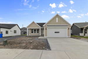 View of front of property with concrete driveway, board and batten siding, covered porch, and an attached garage